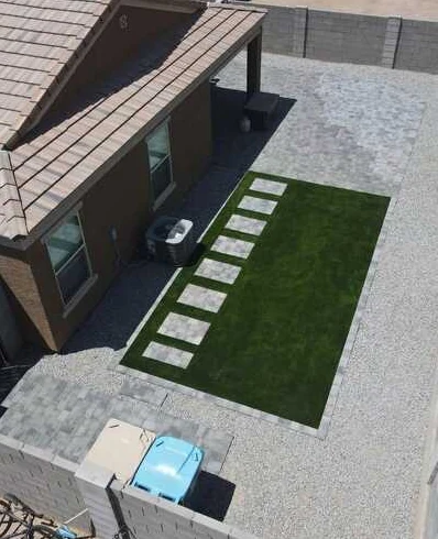Aerial view of turf, evenly spaced paver stepping stones and surrounding gravel.